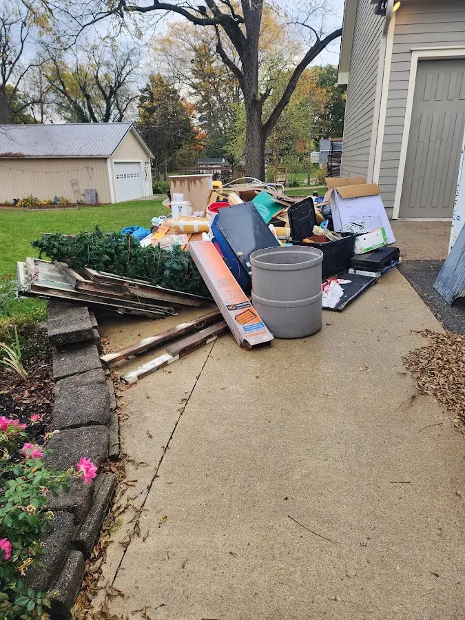 Dumpster being loaded with debris for Estate Cleanout Dumpster Rental in Lake Ridge